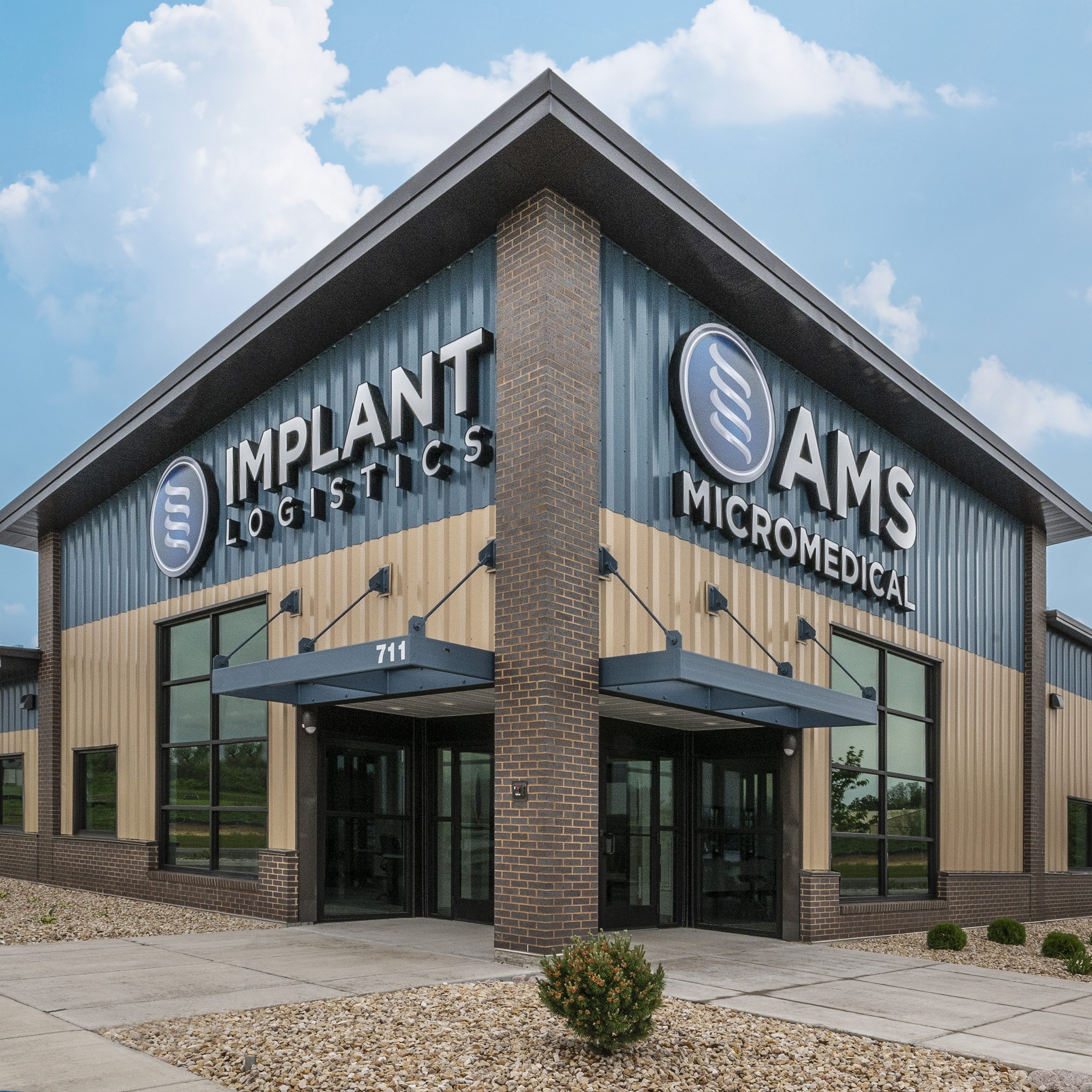Exterior of Implant Logistics and AMS Micromedical building showing signage