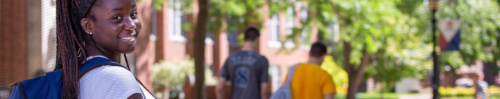 Student looking over her right shoulder and smiling